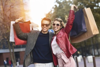 Portrait of a couple with shopping bags in the city.People, sale, love and happiness concept