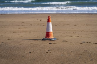 A single pylon on the beach