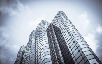 Abstract Diagonal Perspective Of A Towering Downtown Glass And Steel Skyscraper With Copy Space
