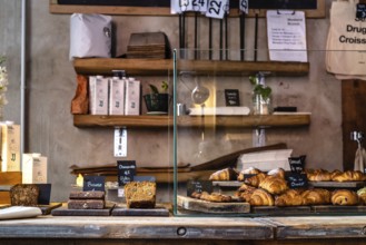 Madrid, Spain, October 17, 2020: Interior of hipster cafe with fresh bakery on counter