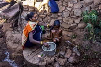 Mother bathing child, Araku, Andhra Pradesh, India, Asia