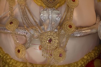 Snake made by silver around belly of Lord Ganesha, Pune, Maharashtra, India, Asia