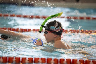 March 10, 2021. Belarus. the city of Gomil. Sports pool. Child athlete swims in the pool