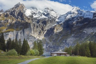 Oeschinnensee lake, wooden chalet and Swiss Alps, Bernese Oberland, Switzerland panorama
