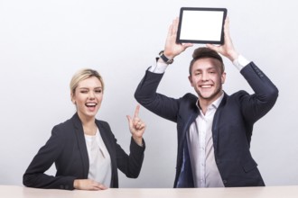 Attractive young caucasian businesswoman with ponytail in black suit and businessman in black suit