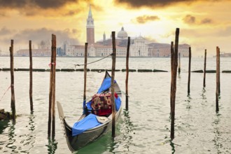 Gondola at sunset pier near San Marco square in Venice, Italy