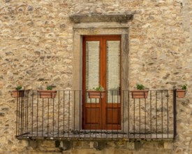 The window and the balcony of an ancient Sicilian medieval house