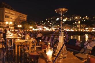 Shisha on the table in restaurant, in the background city Ulcinj in Montenegro at night.