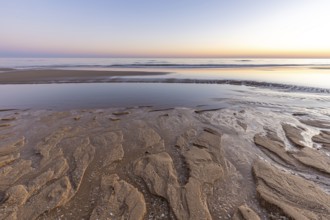 What a sandy beach on the Atlantic. Landscape shot at sunset on a coast with sandstone cliffs. Low
