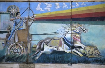Wall mural depicting Saddam Hussein shooting an arrow from a bow while riding down a lion from a Roman war chariot, painting since destroyed, Mosul, Iraq, Middle East/Darstellung Saddam Husseins als F...