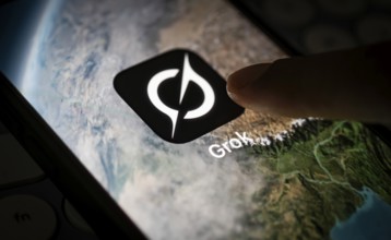 In this photo illustration, a person uses Grok AI chatbot on a mobile phone on March 21, 2025 in