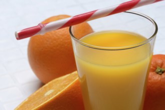 Orange juice in glass and orange