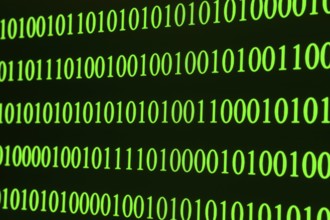 Green binary code in clear rows on a black background