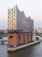 The Elbphilharmonie concert hall in Hamburg is reflected in the glass design above the historic