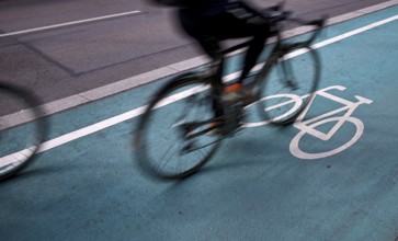Bicycle, cyclist, rides on cycle path, pictogram, logo, labelling, next to road, movement effect,