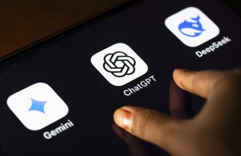 In this photo Illustration a person taps ChatGPT app icon on a tablet device on 24 May 2025 in New