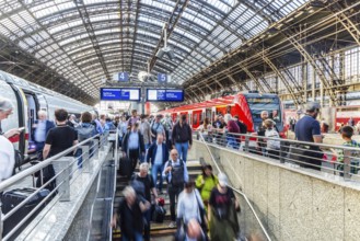 Cologne Central Station. Stairs to the platforms. Travellers waiting for their train on the