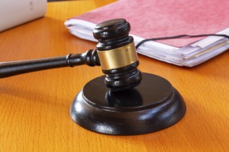 Symbolic image of a court hearing: close-up of a judge's gavel