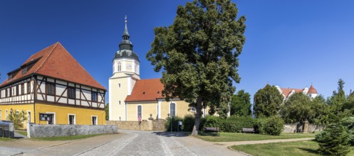 St George's Church and moated castle, Großkmehlen village square, Ortrand, Brandenburg, Germany
