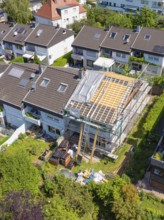 Renovation of a roof in a city environment with scaffolding and summer weather, roof renovation,
