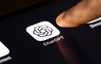 In this photo Illustration a person taps ChatGPT app icon on a tablet device on 24 May 2025 in New