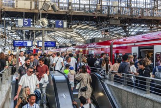 Cologne Central Station. Stairs to the platforms. Travellers waiting for their train on the