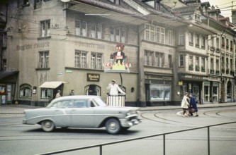 Chevrolet car passes a policeman directing traffic in the city of Bern, Switzerland, Europe 1961