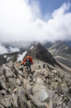 Mountaineer on the summit of Lasörling, cloudy mountain landscape, Lasörling Group, Hohe Tauern