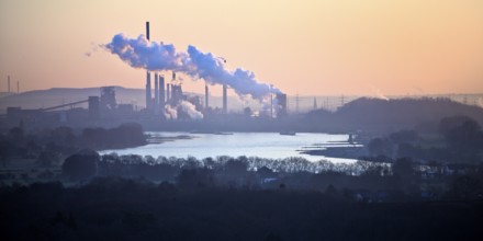 View in front of sunrise from the Rheinpreussen spoil tip onto the Rhine in Duisburg with the
