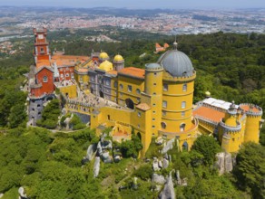 Impressive castle with colourful towers and domed roof on a mountain ridge amidst green trees and