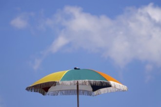 Symbolic picture holiday season, parasol in front of a blue sky, Germany