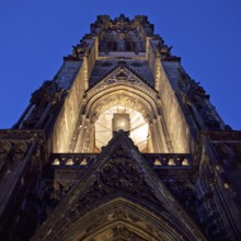 Illuminated church tower of the St. Nikolai memorial, ruins of the former main church of St.
