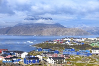 Panoramic view of Greenland capital Nuuk with colored houses located near fjords and icebergs