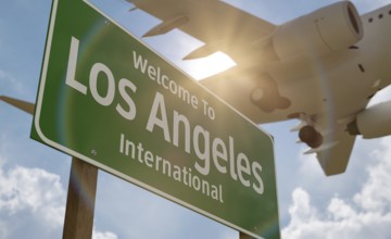 Welcome to los angeles international airport green road sign with airplane above