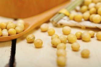 Organic soya beans over rustic wood table macro closeup