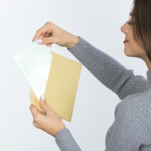 Woman holding envelope with blank paper