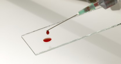 Blood dropping from Needle against White Background