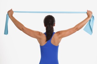 Woman doing sports exercise with Thera-Band, sports exercises