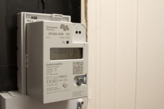 Symbolic image of energy costs in the household, digital electricity meter in a flat, operator