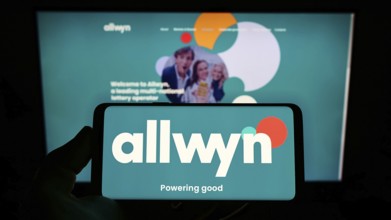 Stuttgart, Germany, 01-22-2022: Person holding mobile phone with logo of company SAZKA