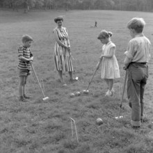 Summer activitiy in the 1950s. A mother and her children are playing croquet. Sweden 1957 Ref 3480
