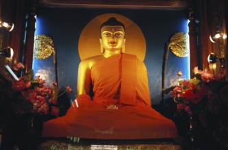 Huge gilded Buddha his hands touching earth inside Mahabodhi temple, Bodhgaya, Bihar, India