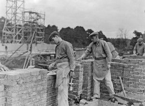 Builders in the 1940s. Two men are laying a brick wall. Sweden 1940s