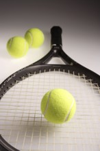 Tennis balls three green color with tennis racket racquet