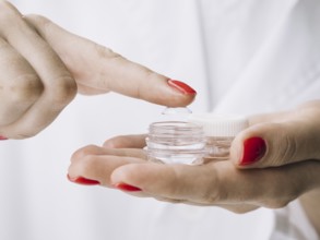 Female pulling out contact lenses from box. Resolution and high quality beautiful photo