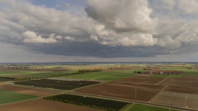 Landscape with wide fields and dramatic clouds in the sky, Straubing, Lower Bavaria, Germany