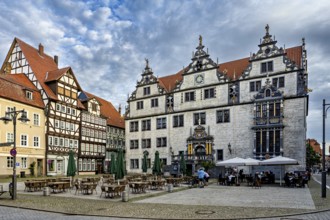 Historic square with half-timbered houses and classic buildings, under a cloudy sky, The historic