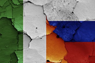 Flags of Ireland and Russia painted on cracked wall