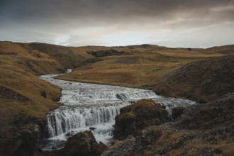 Hestavaðsfoss waterfall at sunrise in Iceland during winter