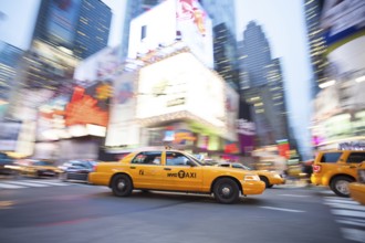 Panning image of a Yellow Taxi cab in Times Square, New York City. New York. USA